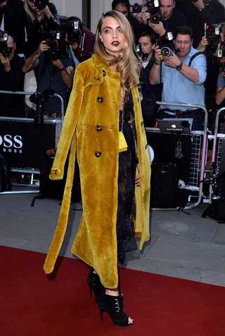 Illustration for article titled Cara Delevingne's Red Carpet Ensemble Is Sheer Madness